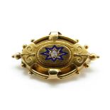 A Victorian brooch set with a diamond surrounded by blue enamel, 3.