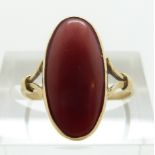 An 18ct gold ring set with a coral cabochon, size K, 2.