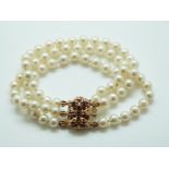 A three strand cultured pearl bracelet with 9ct gold clasp set with sapphires