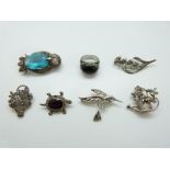 A silver brooch in the form of an owl set with marcasite and a blue gemstone,