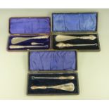 Three cased hallmarked silver handled button hook / shoe horn sets, Birmingham 1900,