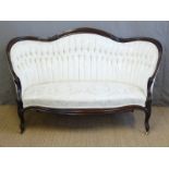 A Victorian upholstered sofa with show wood frame