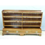 An 19thC or early 20thC inlaid mahogany bookcase with four drawers under by Goodall,