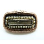 A William IV brooch with textured snake border,