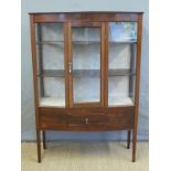A glazed early 20thC display cabinet with single draw below,
