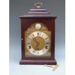 Elliott three-train shelf/bracket style clock in dark wood-stained case.