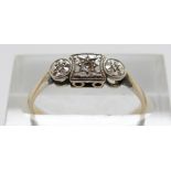 A 9ct gold ring set with three diamonds in a platinum setting, size N, 1.