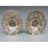 A Victorian pair of hallmarked silver pierced bon bon dish, raised on three ball feet,