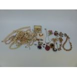 A collection of costume jewellery to include brooches,