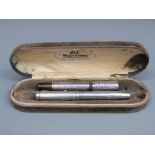 Two white metal cased fountain pens, one stamped Unic Depose and Mecan, the nib marked Swan 2 18ct,