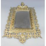 An ornate brass framed bevelled edge mirror marked verso PP,