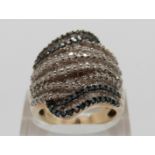 A 9ct gold ring set with round & baguette cut diamonds in a large banded design, size P, 10.