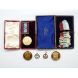 Two 9ct gold Masonic jewels and three Masonic jewels/medals with gold or silver mounts, one 9ct,