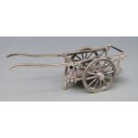 A white metal novelty cart with rotating wheels marked Medusa-Ora, star and 175 AR 925, length 87mm,