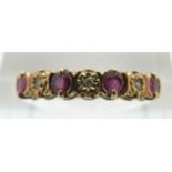 A 9ct gold ring set with alternating diamonds and rubies