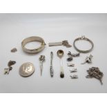 A collection of silver jewellery to include bracelet, ingot, brooch, chains,