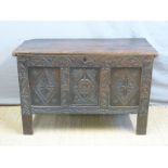 An 18thC carved oak three panel chest or coffer with candle box inside,
