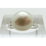 A platinum ring set with a large natural single saltwater pearl measuring approximately 9.9- 10.