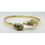 A 14ct gold bangle depicting a leopard and antelope, 14.