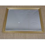 A gilt framed mirror with bevelled edge,