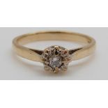 A 9ct gold ring set with a diamond in a platinum setting (size L)