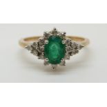 A 9ct gold ring set with an oval cut emerald of approximately 0.