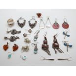 A collection of silver earrings including coral, turquoise,
