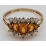 A 9ct gold ring set with citrines and opals, size T, 2.