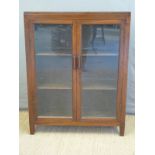 An oak bookcase with glazed doors,