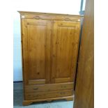 A pine wardrobe with two drawers to base,