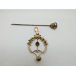 A 9ct gold Edwardian pendant and a 9ct gold pin set with a sapphire