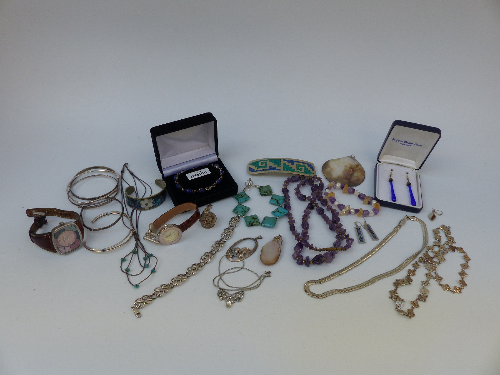 A collection of silver jewellery including a watch, Alpaca brooch and bracelet,