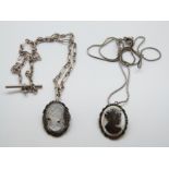 Two silver mounted mother of pearl cameo pendants/ brooches on silver chains