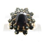 A 9ct gold ring set with an oval sapphire surrounded by tourmaline, size N/O, 4.