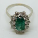 An 18ct gold ring set with an emerald cut apple green emerald of approximately 1.