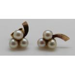 A pair of 9ct gold earrings set with three pearls to each and a gold brooch set with pearls