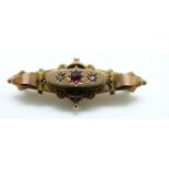 A 9ct gold Victorian brooch set with a red paste and diamonds, glass compartment verso, 2.