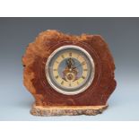 Rustic cased burr walnut mantel clock fitted with battery driven visible movement,