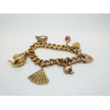 A 9ct gold curb link bracelet with five 9ct gold charms and two heart padlocks, 26.