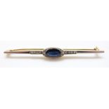 An Art Deco brooch set with an oval sapphire and diamonds with a platinum finish, 4.