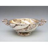 A Victorian hallmarked silver wrythen lobed bowl with twin figural handles,