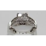 A 14k white gold ring set with four princess cut diamonds, each approximately 0.