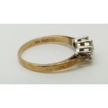 A 9ct gold ring set with three diamonds totalling approximately 0.