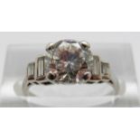 A platinum Art Deco ring set with a round brilliant diamond measuring approximately 1.