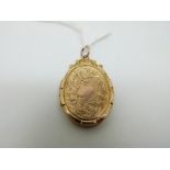 A 9ct gold Edwardian locket with scrolling engraved decoration,