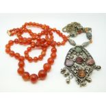 A graduated beaded carnelian agate necklace and a white metal necklace set with rose quartz,