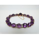 A 9ct gold Victorian bracelet set with graduated purple paste stones