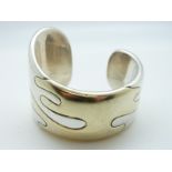 A white metal bi-coloured bangle in a bespoke design with signature to inside