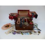 A leather jewellery box and rosewood box containing costume jewellery including Miracle brooch,