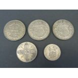 Three half crowns, 1923, 1926 and 1935, together with a 1923 florin and a 1925 shilling,